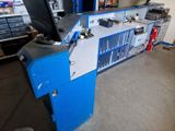 a computer desk with a monitor on it in a garage