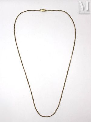 a gold necklace with a chain that has a cross on it