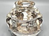 a silver bowl that is sitting on top of a table