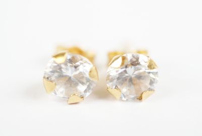 pair of diamond stud earrings on a white background