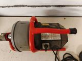 an image of a red and black electric drill