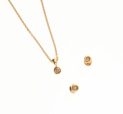 un gros plan d'un ensemble composé d'un collier et de boucles d'oreilles en or sur fond blanc