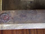 a piece of wood that has writing on it