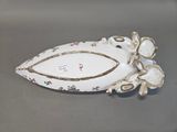 a white plate with a bird on it sitting on a table
