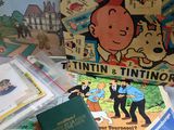 a box of tintintin and tintin books on a table