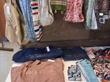 a suitcase full of clothes and ties on a table