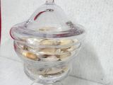 a glass jar with cookies in it sitting on a counter