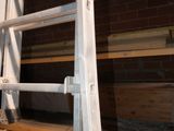 a ladder that is sitting on the floor in front of a brick wall