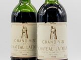 two bottles of wine sitting next to each other on a table