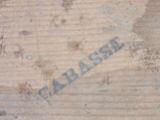 a close up of a piece of wood with writing on it