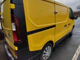 a yellow van that is parked in a parking lot