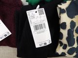 three pairs of black and white socks and a green and black scarf