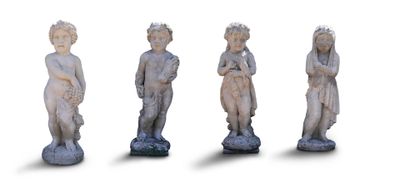 three statues of children are standing in a row on a white surface