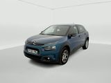 a blue car is parked in a white room with a white floor