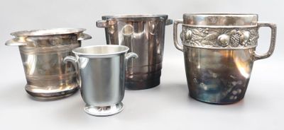 four silver vases and two silver cups on a table