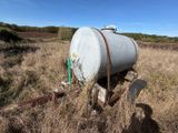 a tank that is sitting in the middle of a field