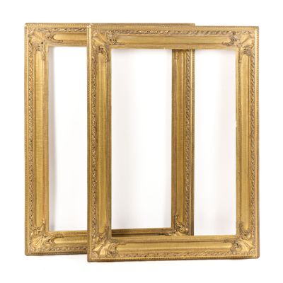a pair of antique gold picture frames on a white background