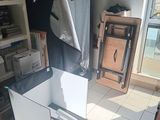 a refrigerator in the middle of a kitchen with a towel hanging from it ' s door