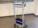 a hand truck with a blue bag on it in a room