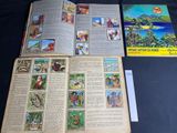 an open book on a table with pictures of people and animals