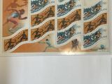a picture of a stamp with a picture of athletes on it