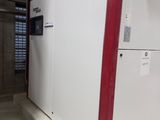 a white refrigerator with red trims in a building