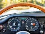 a steering wheel of a car with a speedometer and gauges