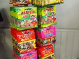 many bags of candy stacked on top of each other