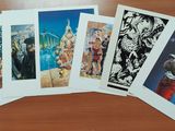 five cards on a table with pictures of people on them
