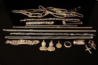 several different types of jewelry are displayed on a black surface