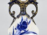 a blue and white vase sitting on a table