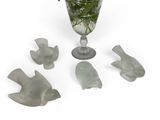 a vase with flowers in it next to four birds