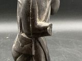 an old photo of a statue of a woman holding a child