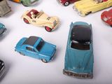 many toy cars that are sitting on a white surface
