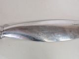 a silver spoon that is on a white table