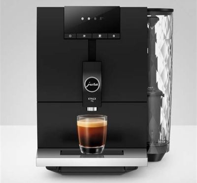 a coffee machine with a glass of coffee on top of it