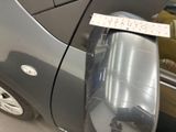 a picture of a car door handle with a sticker on it
