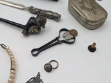 a table with various items on it including a necklace, bracelet, and other items