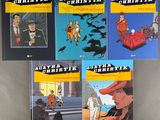 four books on a table, one of which has a picture of a man in a hat and the other