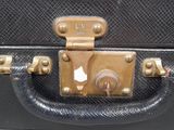 an image of a black suitcase with a gold lock