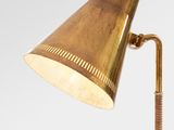 a brass table lamp with a wooden base and a brass shade