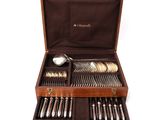 a wooden box with silverware in it on a white surface