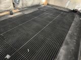 a large metal grate on the floor in the room