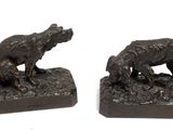 pair of bronze sculptures of a dog and a cat on a rock