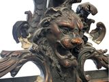 a large ornate mirror with a lion head on it
