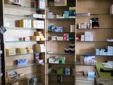 a large open pharmacy cabinet in the corner of the room