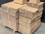 a stack of cardboard boxes on a pallet in a warehouse