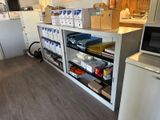 many boxes on the shelves in the kitchen
