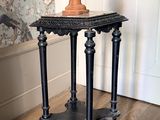 une petite table sur laquelle est posé un buste