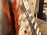a ladder leaning against a wall next to a pile of surfboards